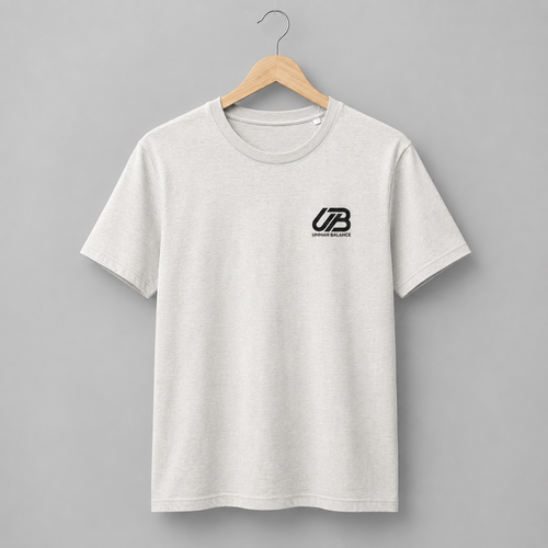 A vintage white short-sleeve crewneck t-shirt hanging on a wooden hanger. The shirt features a black small 'UB' logo on the left chest with 'Ummah Balance' printed underneath.