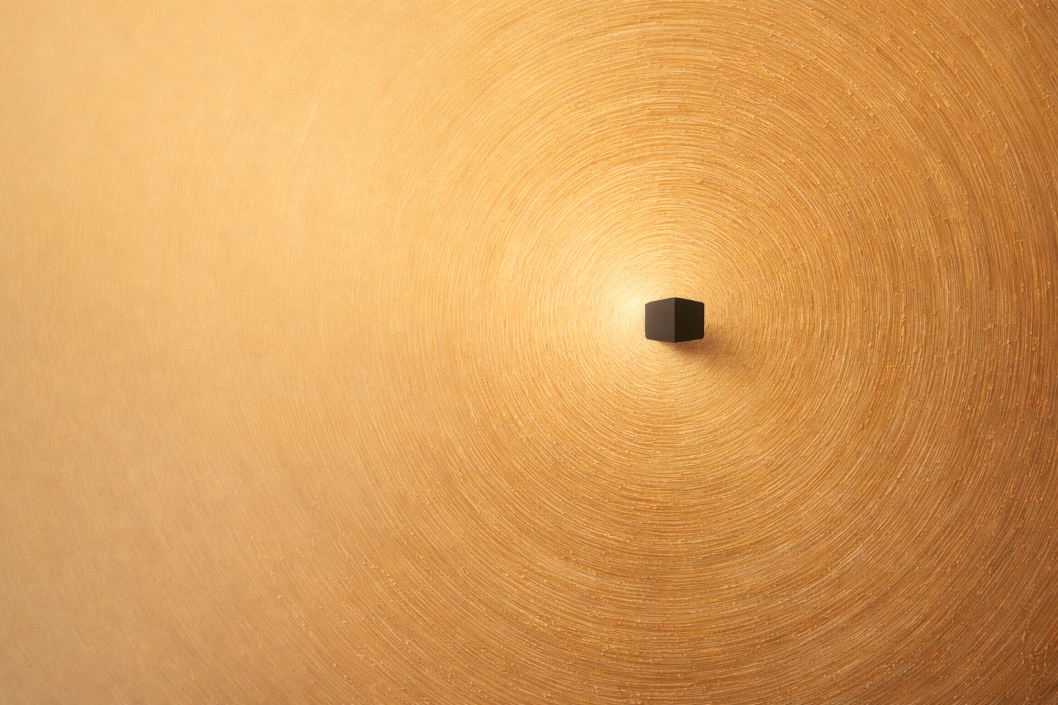 The Ka'bah depicted as simple black cube on a circular textured gold background.