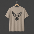 A dessert dust coloured short-sleeve t-shirt hanging on a wooden hanger. The back of the shirt features a large black abstract geometric bird graphic with the words 'LOVE. FEAR. HOPE.' in black in the middle. 