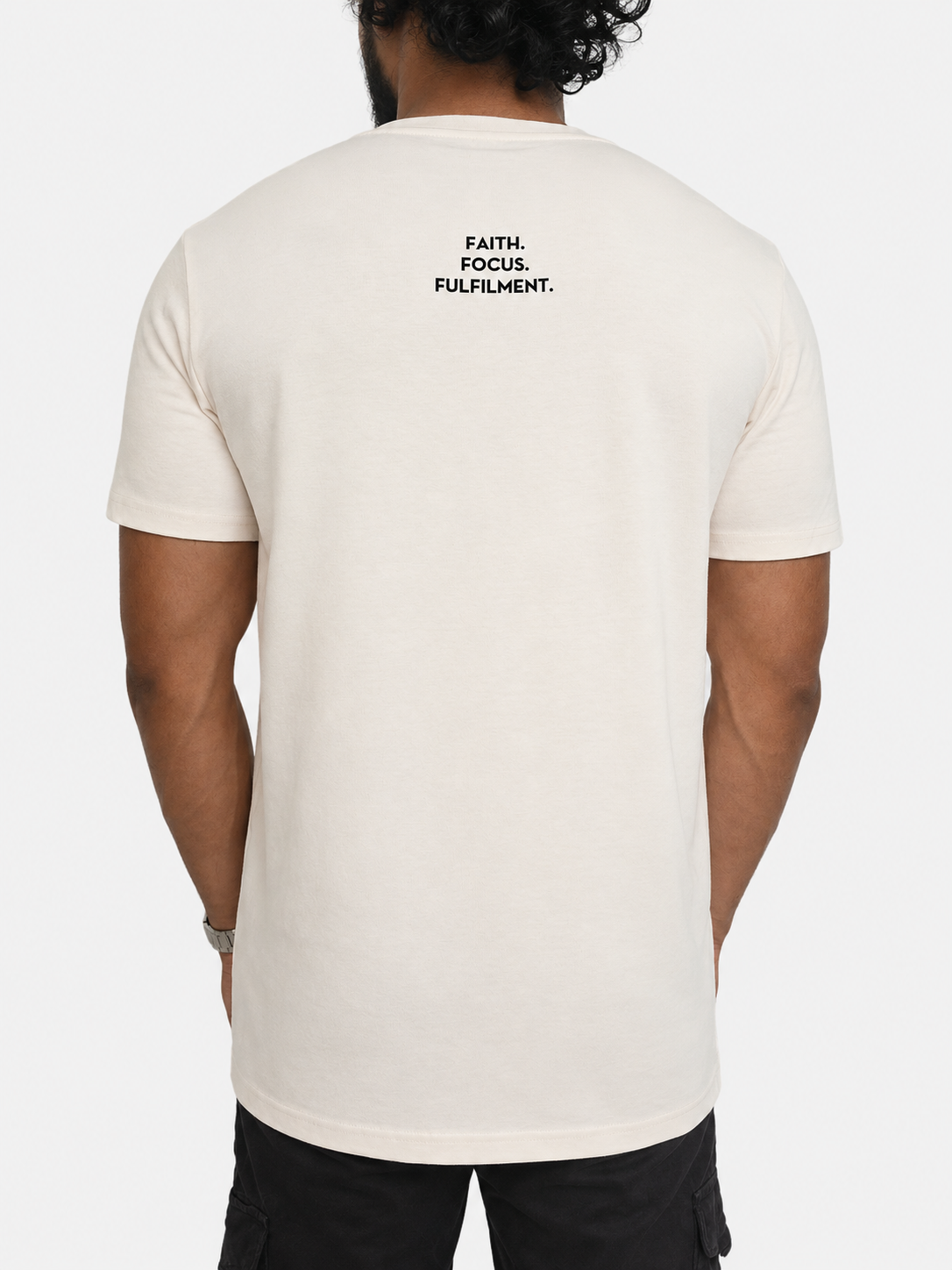 A man viewed from the back wearing a vintage white-coloured t-shirt with the words 'FAITH. FOCUS. FULFILMENT.' between shoulder blades